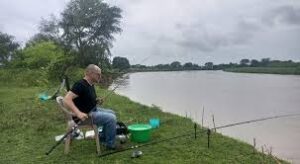 A fishing excursion setup on the lush, green riverbanks of the Semliki River in Bweramule, Uganda