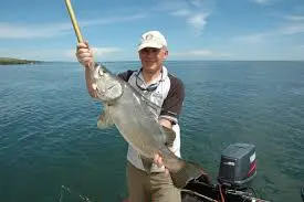Angler holding a large Nile Perch caught during a Lake Victoria fishing trip in Kenya