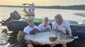 Angler holding a massive Nile Perch caught during the best fishing safari Kenya offers at Kisumu