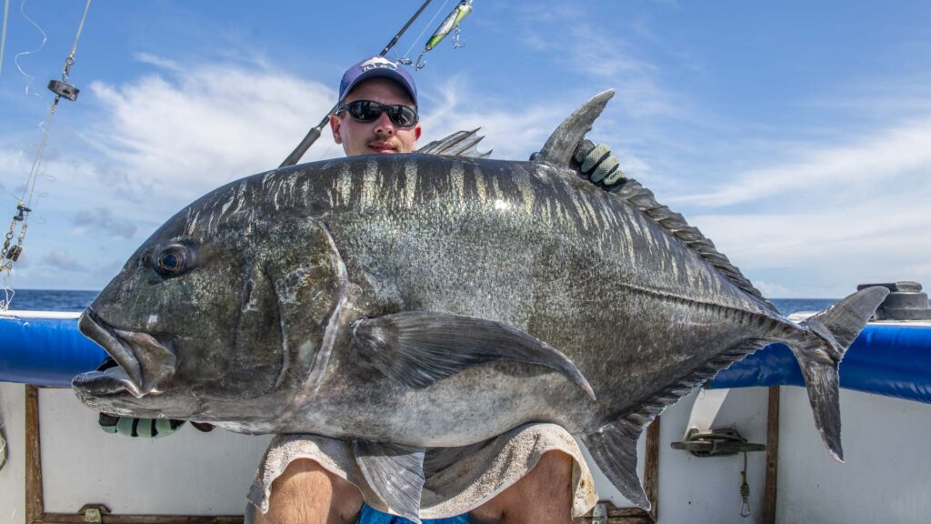 Deep Sea Fishing Charters Mombasa Big Game Fishing | Deep Sea Fishing Charters Best Fishing Safaris at Zanzibar An angler holding a large sailfish caught during a deep-sea fishing trip in Zanzibar full day fishing in Zanzibar
