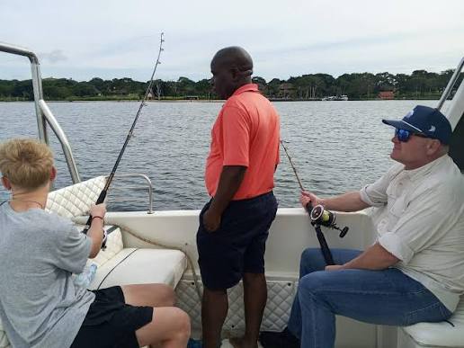 Fishing and Shoebill Safari on Lake Victoria Experienced fishing guide helping an angler catch a Nile perch during a guided fishing tour in Uganda by Peter’s Fishing Tours Uganda