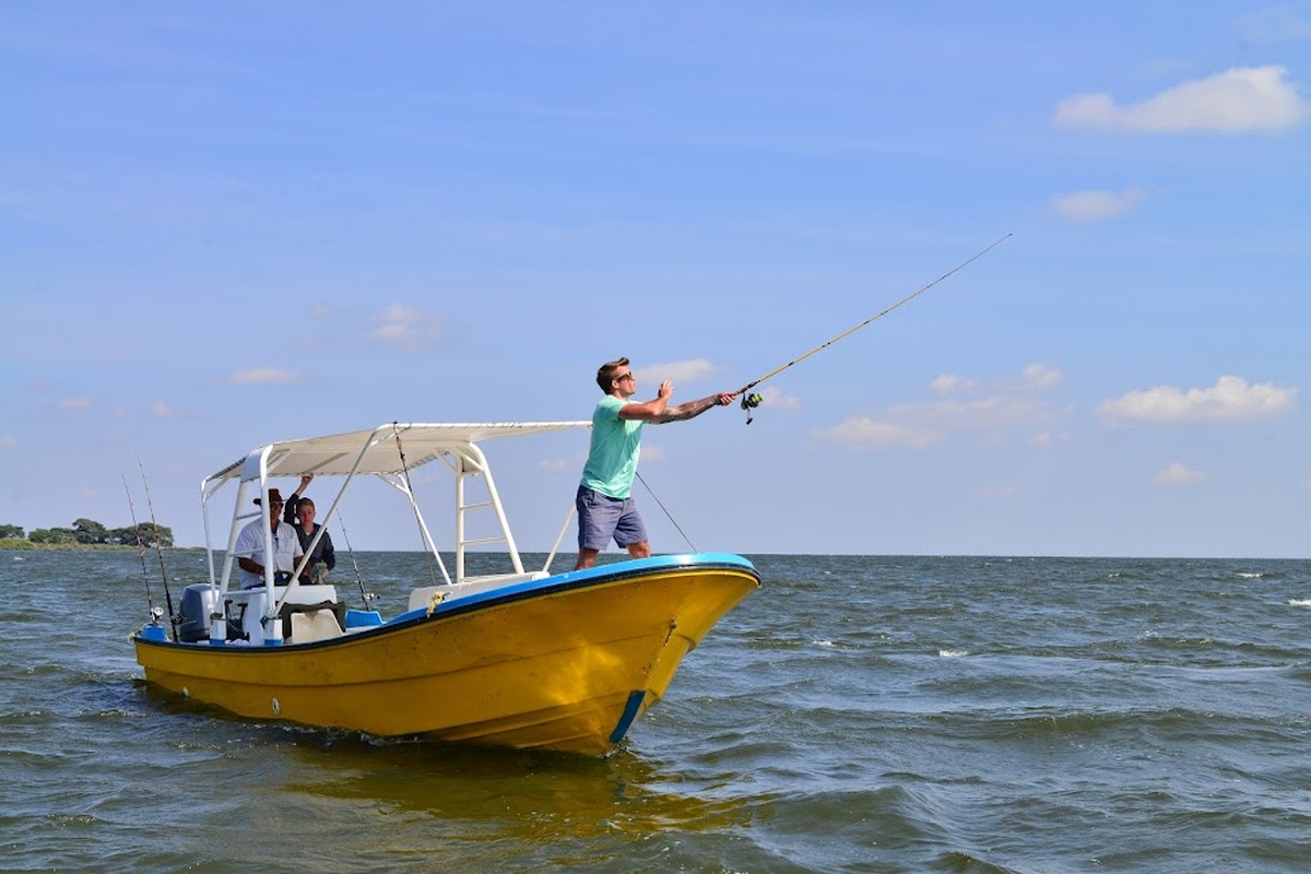 Nile Perch Fishing in Uganda Angler fishing from a boat on Lake Victoria in Uganda